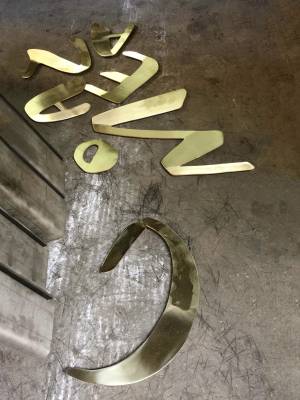 Site Practice - Brass Americano signage in the workshop 